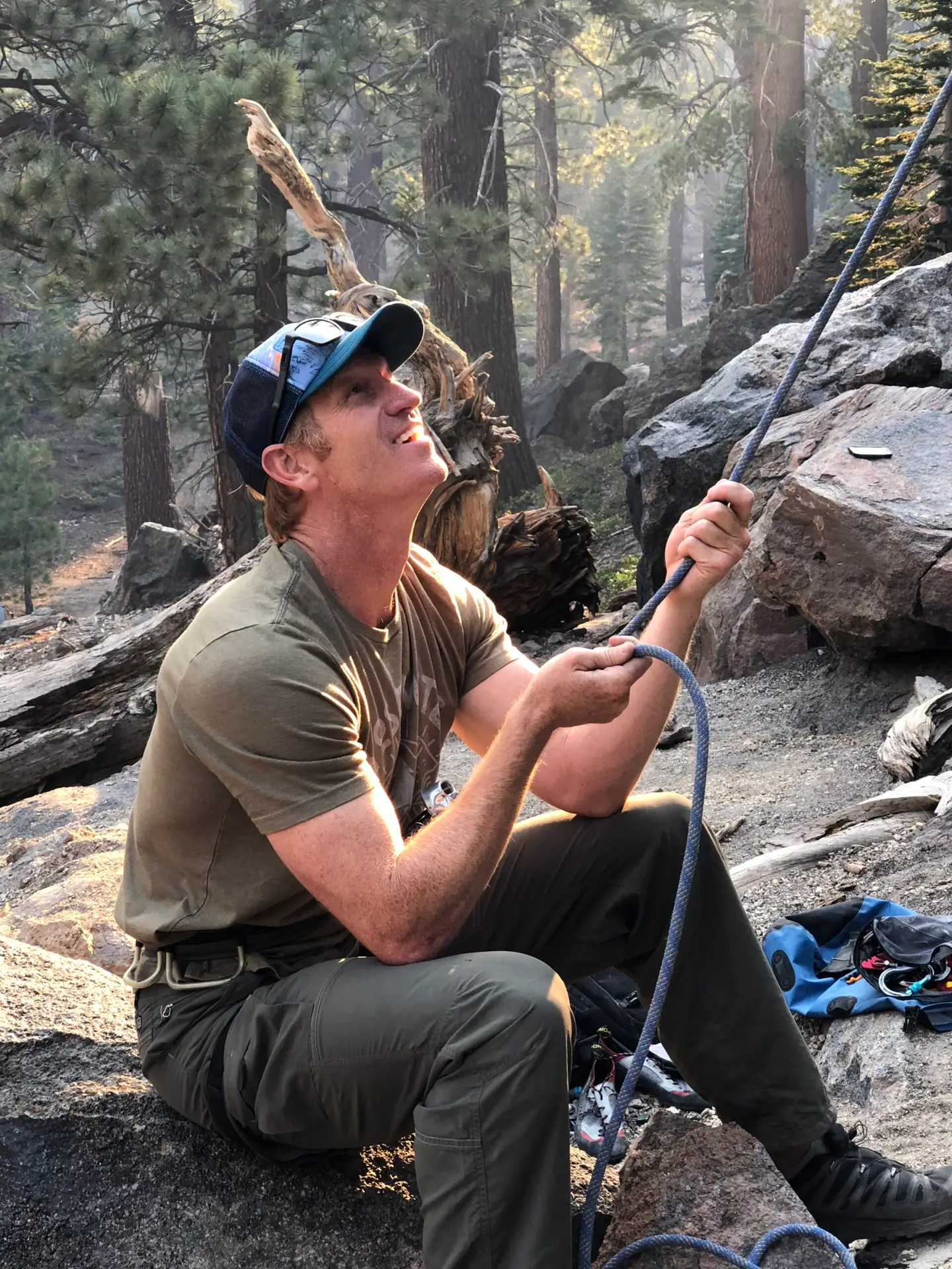 Founder Brad Hunter with a climbing rope in the forest